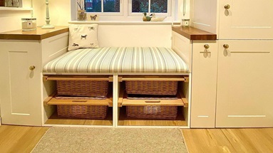 An easy-access boot room storage idea with open shelves and pull-out wicker baskets for essentials.