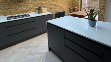 Clerkenwell Super Matt Charcoal kitchen island with integrated handle kitchen doors and solid worktop.