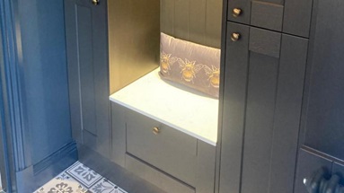 jamesandgemma2 boot room seating area using Fairford charcoal cabinets, brass door knobs, and spot lighting.