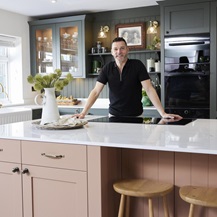 Fred stood in his kitchen, behind the counter.