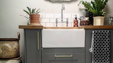 Grey boot room idea with shaker kitchen doors, white butler sink, silver bridge tap.