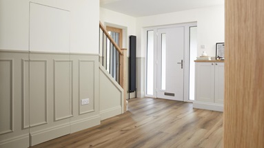 An entrance area in a Courtney's house, complete with secret storage space created with wall panels.