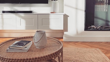 Minimal living room idea with a bespoke, wall-hung TV unit made from white, shaker cupboard doors with a smooth finish.