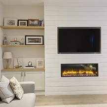 Simple living room idea using open shelving made from oak worktop offcuts. Has white shaker storage units and timber floors.