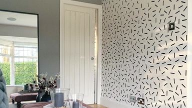 A timeless living room idea featuring a white, tongue-and-groove door, grey painted walls, and pale oak-effect flooring.