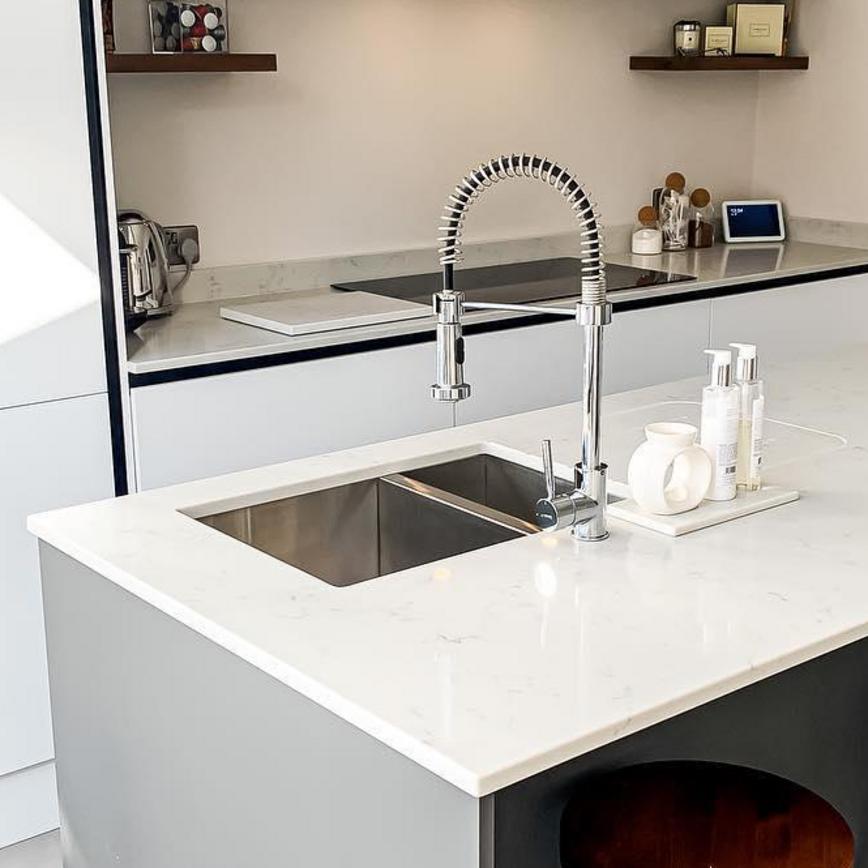 A modern kitchen sink idea using a stainless-steel sink in a 1.5 bowl style and inset design for a streamlined look.