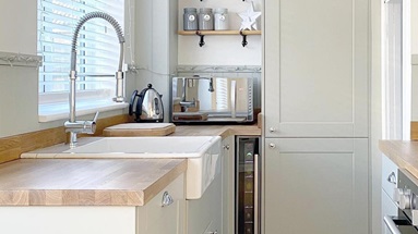 Allendale small shaker kitchen in a dove grey finish. It features a shallow butler sink and Howdens spray tap.