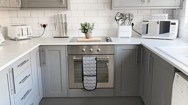 A grey shaker kitchen with brand new oven and induction hob