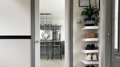 A white glzed kitchen door in a bright white hallway