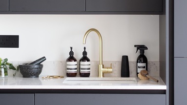 Undermount sink with brass tap and white workop