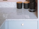 Brushed brass knob handles on super matt grey door