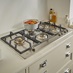 Bertazzoni 90cm 4 Zone Hob With Wok Burner and Pan Angled View in Kitchen Set