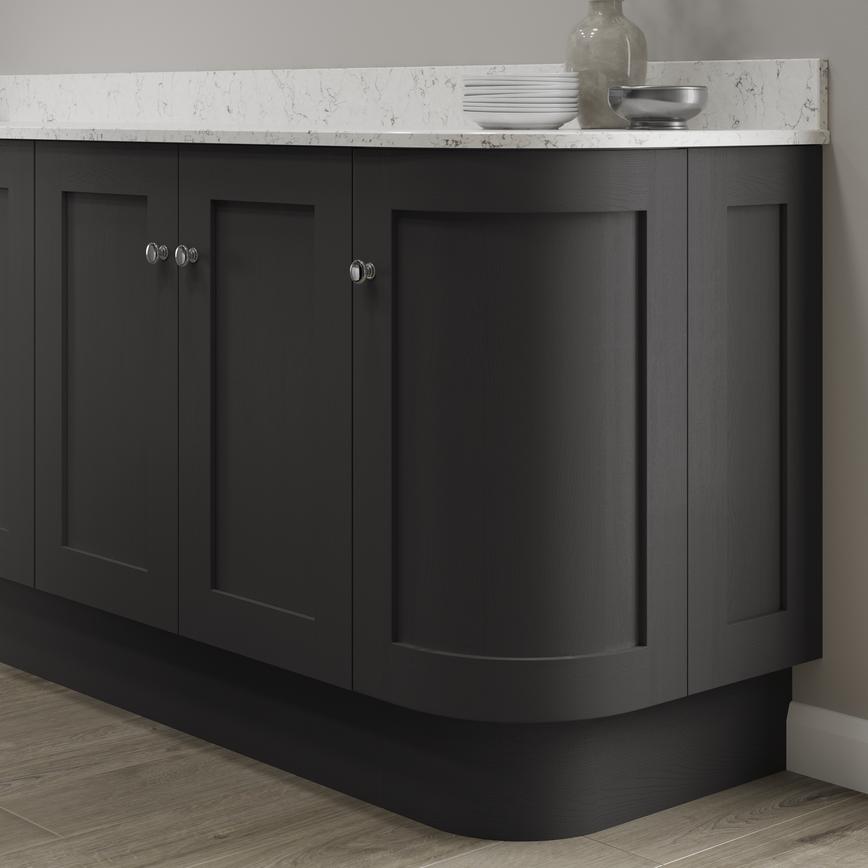 Charcoal curved base end plinth fitted with base cabinet and white worktop