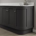 Charcoal curved base end plinth fitted with base cabinet and white worktop