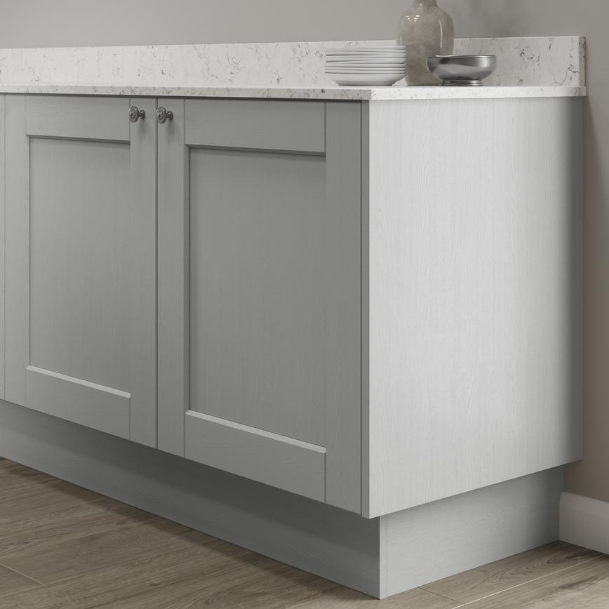 Grained dove grey continuous MFC plinth fitted with base cabinet and white worktop