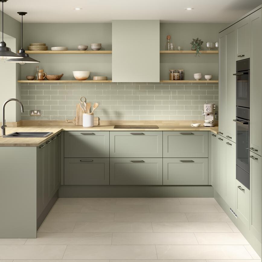 A modern shaker kitchen from the Frome collection in a reed green tone. It has white, tile flooring and a u-shaped layout.