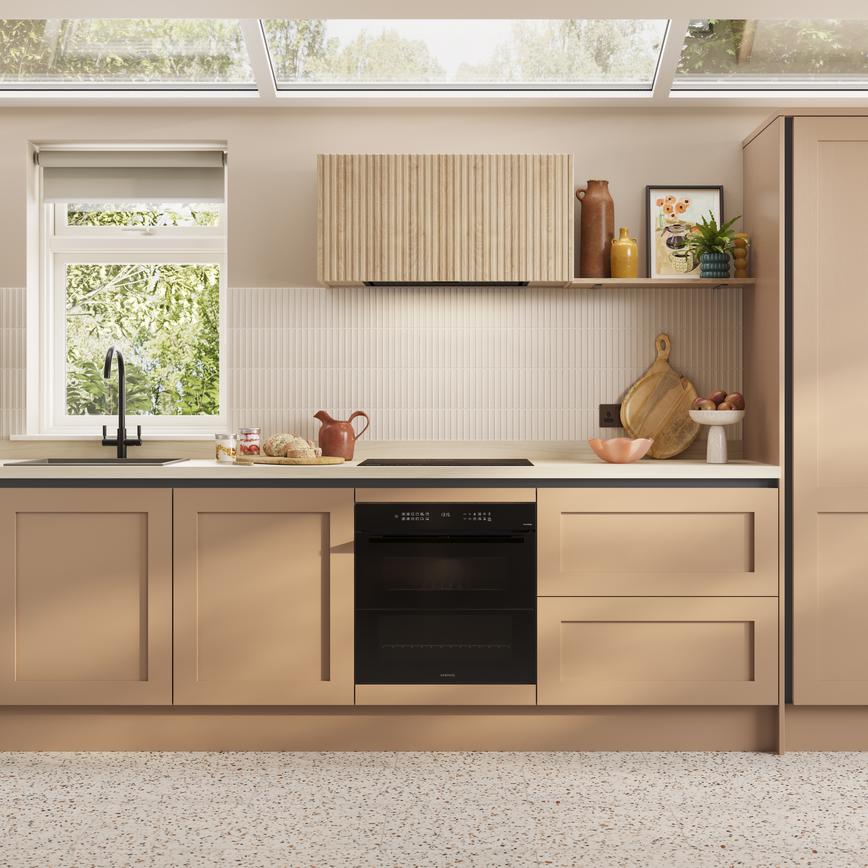 A handleless kitchen idea featuring terracotta cupboards. Includes shaker doors, white worktops, and black metal profiles.