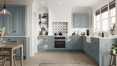 Painted shaker kitchen with in-frame profiles in an L-shaped layout. Includes white worktops, chrome handles, and white sink.