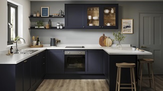 A U-shaped kitchen layout with navy, shaker doors. Includes white worktops, glass wall units, and a black, induction hob.