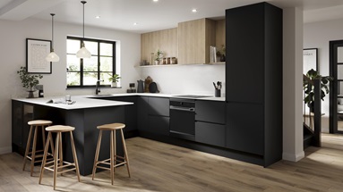 A black kitchen in a U-shaped layout with integrated handle cupboards. Includes white, marble-effect worktops and oak floors.