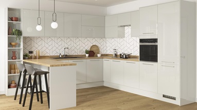 Dove grey reflective mirror gloss kitchen in a u shape with integrated breakfast bar and chrome kitchen door handles.