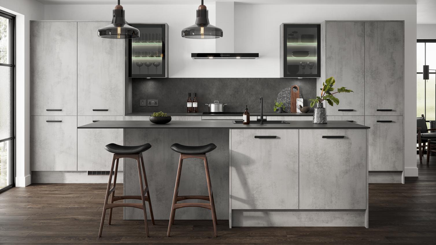 Grey kitchen in an island layout with concrete cupboard doors in a slab design. Includes black bar handles and glazed units.