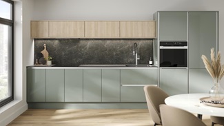 A handleless kitchen in a gloss finish and reed green colour. It has textured oak wall cabinets and black quartz splashback.