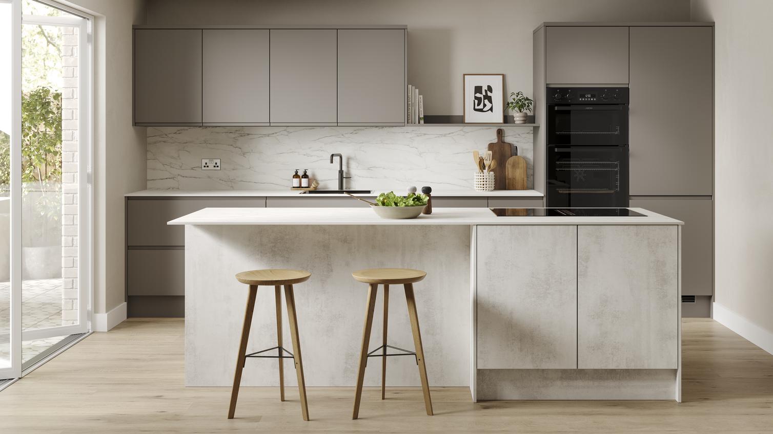 A slab, white stone kitchen in a single-wall layout with a textured finish. It has oak wall cabinets and a white worktop. 