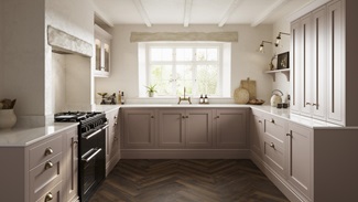A pink shaker kitchen, in an antique rose shade from the Ilfracombe collection. It has dark oak herringbone flooring.