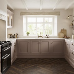 A pink shaker kitchen, in an antique rose shade from the Ilfracombe collection. It has dark oak herringbone flooring.