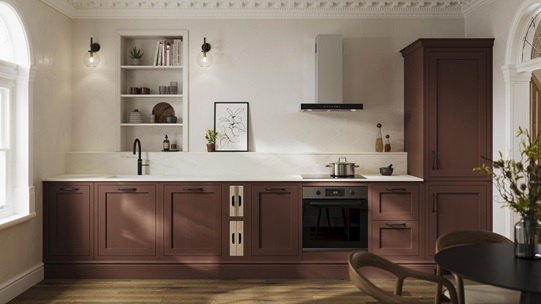 An earth red shaker kitchen from Ilfracombe in a single-wall layout. It has black accessories and a marble-style worktop.
