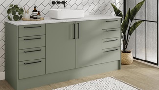 Reed green bathroom with slab doors and matt finish for a modern design. Includes oak-effect flooring and slim black handles.