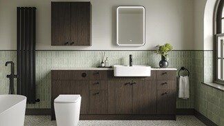 A bathroom with textured units in a walnut-effect finish. It has white fixtures, matching wall cabinets and painted panels.