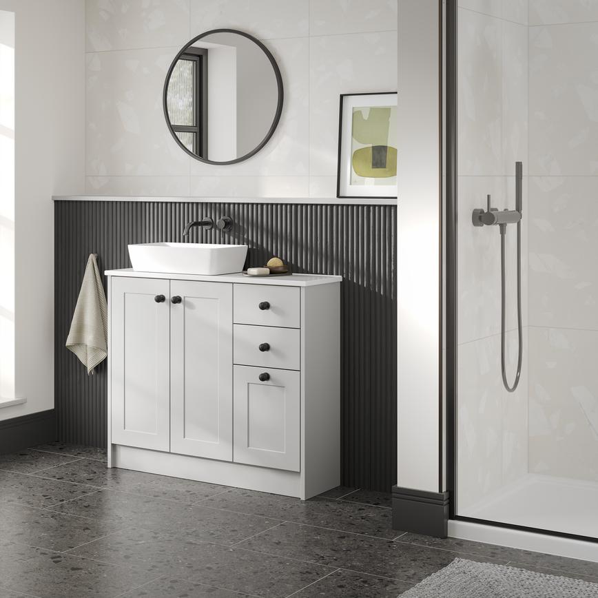 A single-wall, shaker bathroom in a dove grey tone. It has tile flooring, a ceramic sink, and dark oak wall panelling.