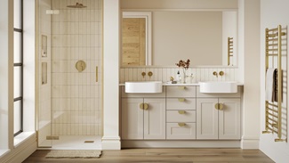 A single-wall, shaker bathroom in a sandstone tone. It has gold taps and handles, dual ceramic sinks, and timber flooring.