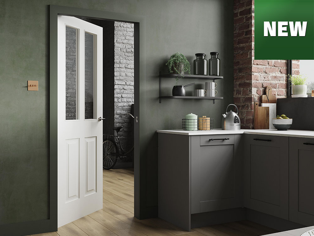 Modern kitchen with green wall, open white door, and grey cabinets and new logo